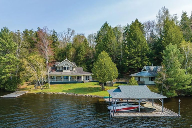 Realtor posing lakeside with waterfront view